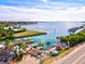 Scenic view of a waterfront bistro, showcasing a tranquil harbor with boats, docks, and a lush landscape at 14098 Baracoa Ln, Port Charlotte, FL 33981