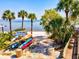 Picturesque waterfront scene with colorful kayaks near palm trees and a sandy beach at 14098 Baracoa Ln, Port Charlotte, FL 33981