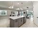 Modern kitchen with island, stainless steel appliances, and breakfast bar at 14454 Little Eagle Loop, Nokomis, FL 34275