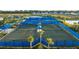 Aerial view of community tennis courts with blue fencing at 14454 Little Eagle Loop, Nokomis, FL 34275