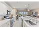 Open kitchen boasts stainless steel appliances and white cabinets at 157 Tampa E Ave # 208, Venice, FL 34285