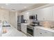 Bright kitchen featuring stainless steel appliances and white cabinets at 157 Tampa E Ave # 208, Venice, FL 34285