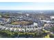 Aerial view of a community with houses surrounding a lake at 1584 Monarch Dr, Venice, FL 34293