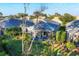 Aerial view showcasing a home with a screened patio and lush landscaping at 1584 Monarch Dr, Venice, FL 34293