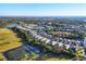 Aerial view of houses and a golf course at 1584 Monarch Dr, Venice, FL 34293