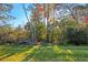 Backyard with mature trees and lush landscaping at 1584 Monarch Dr, Venice, FL 34293