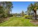 Backyard view showcasing a pond and lush landscaping at 1584 Monarch Dr, Venice, FL 34293