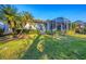 Home's backyard features a large screened patio and lush lawn at 1584 Monarch Dr, Venice, FL 34293