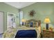 Bedroom with wood bed frame and ensuite bathroom at 1584 Monarch Dr, Venice, FL 34293