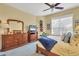 Bedroom with wood dresser and blue accents at 1584 Monarch Dr, Venice, FL 34293