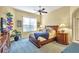 Spacious bedroom with wood furniture and blue carpet at 1584 Monarch Dr, Venice, FL 34293