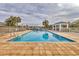 Inviting community pool with lounge chairs and a shaded seating area at 1584 Monarch Dr, Venice, FL 34293