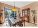Spacious dining area with a china cabinet and sliding glass doors to a patio at 1584 Monarch Dr, Venice, FL 34293