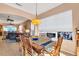 Bright dining room with wooden table and chairs, view to living room at 1584 Monarch Dr, Venice, FL 34293