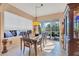 Bright dining room with a wooden table, chairs, and access to the lanai at 1584 Monarch Dr, Venice, FL 34293