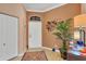 Bright and airy entryway with a coat closet and decorative wall art at 1584 Monarch Dr, Venice, FL 34293