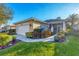 Single-story home with attached garage and landscaped yard at 1584 Monarch Dr, Venice, FL 34293