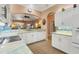 Spacious kitchen with white cabinets, granite countertops, and tile floors at 1584 Monarch Dr, Venice, FL 34293