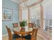 Bright kitchen nook with wood table and chairs, near window at 1584 Monarch Dr, Venice, FL 34293