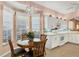 Kitchen nook with table and chairs and view into kitchen at 1584 Monarch Dr, Venice, FL 34293