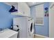 Laundry room with washer, dryer, and built-in cabinets at 1584 Monarch Dr, Venice, FL 34293