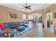 Open living area with a sectional sofa, tile floors, and access to the dining area at 1584 Monarch Dr, Venice, FL 34293