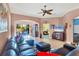Comfortable living room with a sectional sofa and views to the lanai and dining area at 1584 Monarch Dr, Venice, FL 34293
