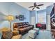 Home office features a leather sofa, desk, and ample natural light at 1584 Monarch Dr, Venice, FL 34293
