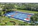 Well-lit pickleball courts surrounded by lush landscaping at 1584 Monarch Dr, Venice, FL 34293