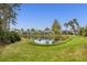 Pond view with multiple homes in the background at 1584 Monarch Dr, Venice, FL 34293