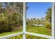 Relaxing screened porch overlooks a pond and lush landscape at 1584 Monarch Dr, Venice, FL 34293
