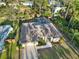 Single-story home with pool and large backyard, surrounded by lush trees at 1684 Ruiz St, North Port, FL 34286