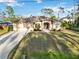 One-story house with a two-car garage and a large front yard at 1684 Ruiz St, North Port, FL 34286