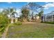Large backyard with tropical landscaping and partial pool view at 1684 Ruiz St, North Port, FL 34286