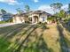 Single-story home with a two-car garage and landscaped yard at 1684 Ruiz St, North Port, FL 34286