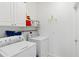 Laundry room with washer, dryer, and overhead storage at 1684 Ruiz St, North Port, FL 34286
