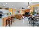 Open living area with leather sectional sofa and adjacent kitchen at 1684 Ruiz St, North Port, FL 34286