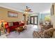 Comfortable living room with red couch and access to patio at 1684 Ruiz St, North Port, FL 34286