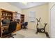 Home office with built-in shelving and a stationary bike at 1684 Ruiz St, North Port, FL 34286