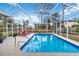 Inviting screened pool with lounge chairs, perfect for relaxation at 1684 Ruiz St, North Port, FL 34286