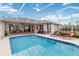 Inviting screened pool and patio area with lounge chairs at 1684 Ruiz St, North Port, FL 34286