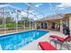 Relaxing screened pool and patio area with lounge chairs at 1684 Ruiz St, North Port, FL 34286