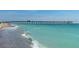 Beach scene featuring a pier and people enjoying the clear water on a sunny day at 1721 Dogleg Dr, Venice, FL 34285