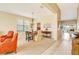 Neutral colored dining room with an adjacent living area with tile floors at entrance at 1721 Dogleg Dr, Venice, FL 34285