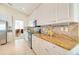 Well-lit kitchen with white cabinets, granite countertops, and stainless steel appliances at 1721 Dogleg Dr, Venice, FL 34285