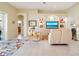 Bright living room with neutral tones, a large media center, and sliding glass doors to the outdoor space at 1721 Dogleg Dr, Venice, FL 34285