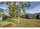Spacious backyard with lush landscaping and screened enclosure at 1723 N Gondola Ct, Venice, FL 34293
