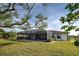 Relaxing backyard oasis featuring a screened pool and lush lawn at 1723 N Gondola Ct, Venice, FL 34293