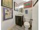 Small bathroom with dark vanity and decorative artwork at 1723 N Gondola Ct, Venice, FL 34293