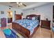 Main bedroom with a king-size bed, wood furniture, and water views at 1723 N Gondola Ct, Venice, FL 34293